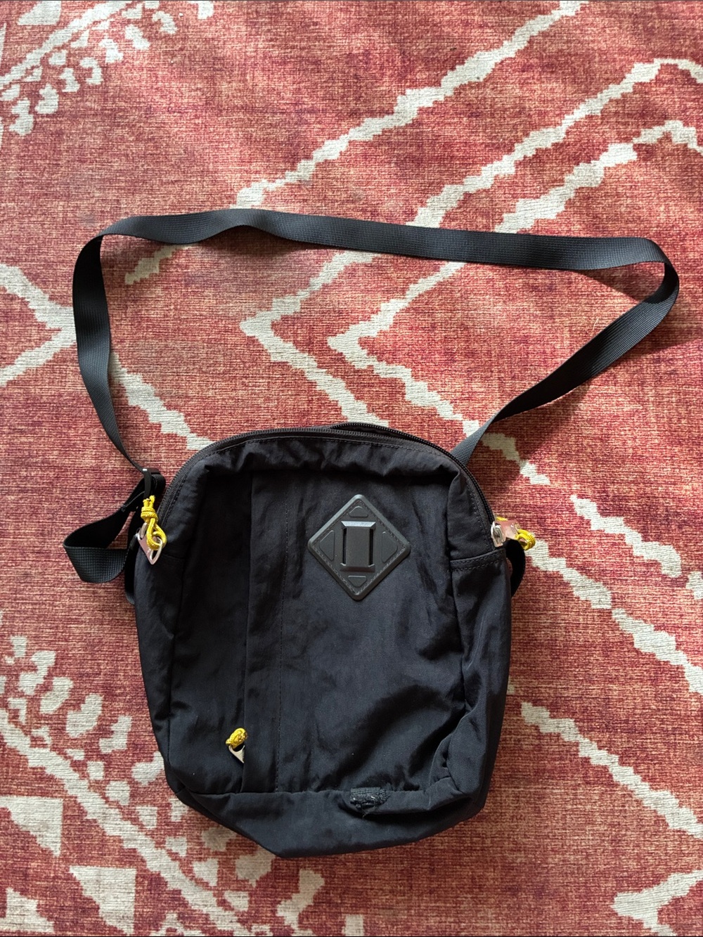 The North Face Black Crossbody Bag with Yellow Accents